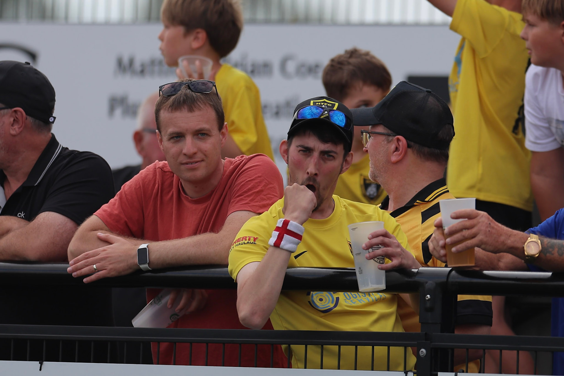 Harborough Town supporters watching from behind the pitch barrier